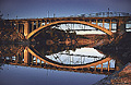 View of the Rainbow bridge over calm water just before sunset. Notice the return of the original bridge being reinstalled just behind the Rainbow bridge. Folsom, CA 'Nikon F100 35mm SLR' (Click for larger view)