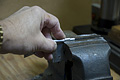 Step 2 of makeing a ground clamp - crimping the stap (Click for larger view)
